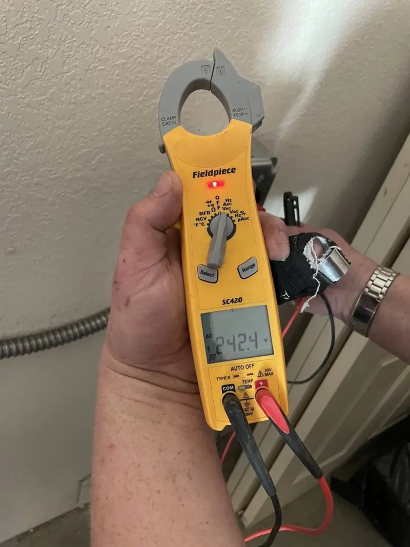 Voltage testing with clamp meter during Ceiling Fan Installation in Hondo